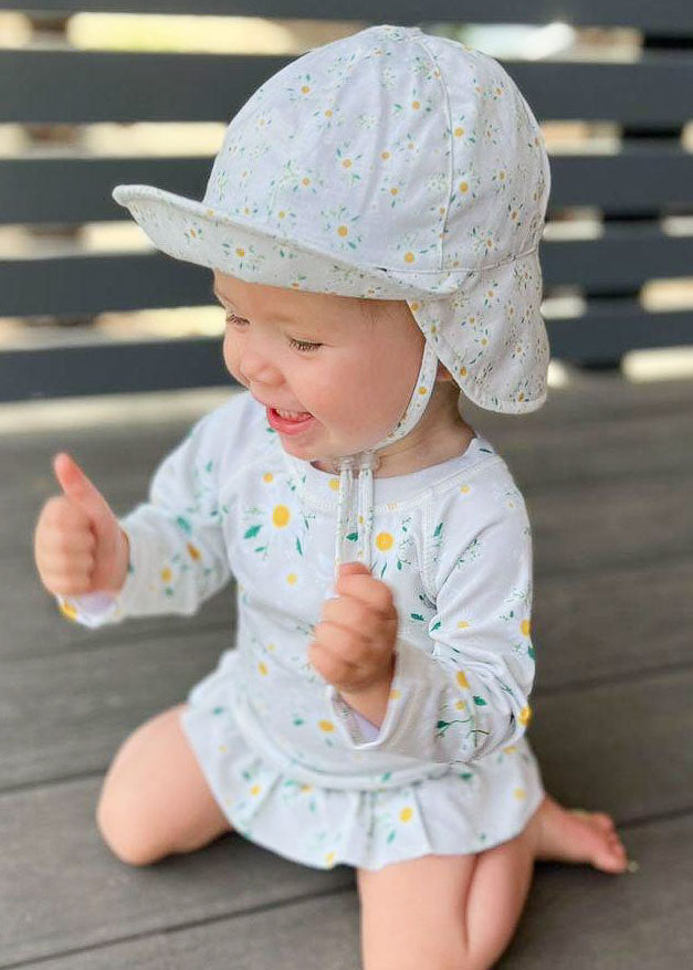 baby girl wearing hat with flap
