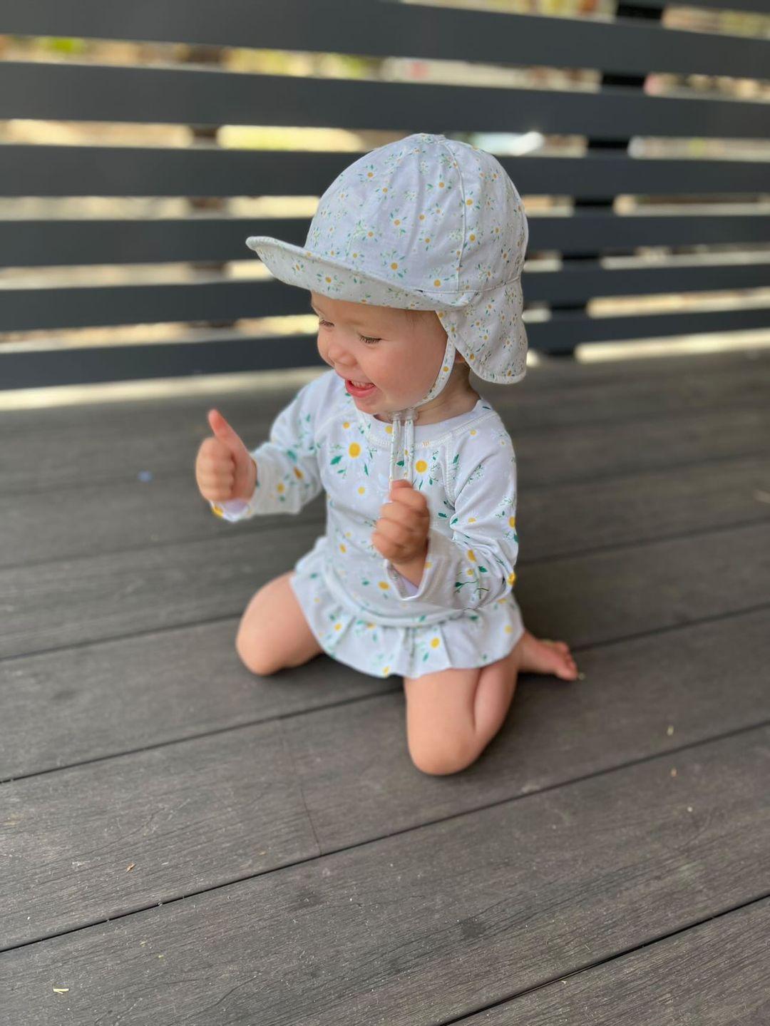 baby girl wearing matching hat and swimsuit