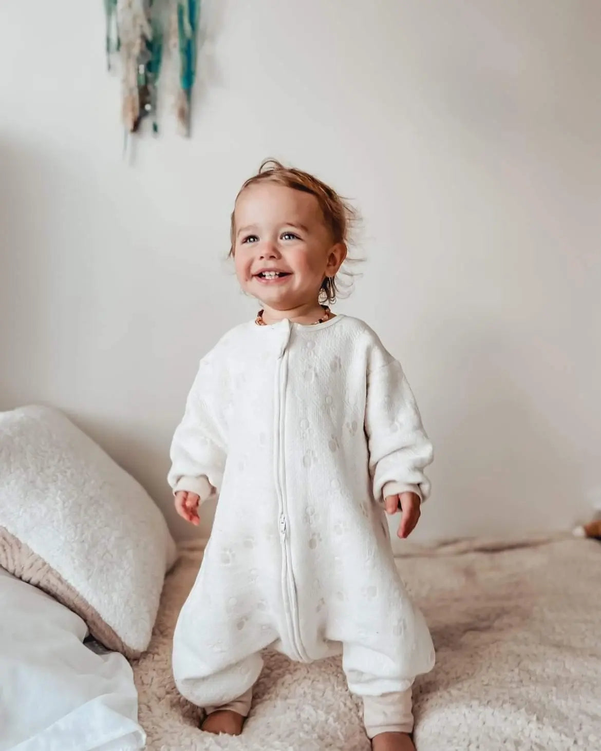 Baby boy wearing sleepsuit with paws pattern