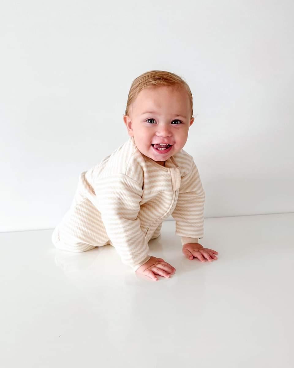 baby wearing sleep suit