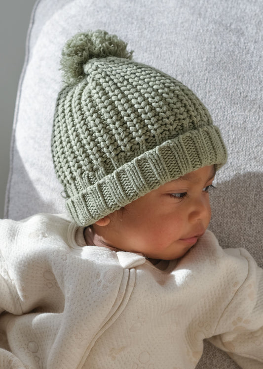 baby wearing green knitted beanie