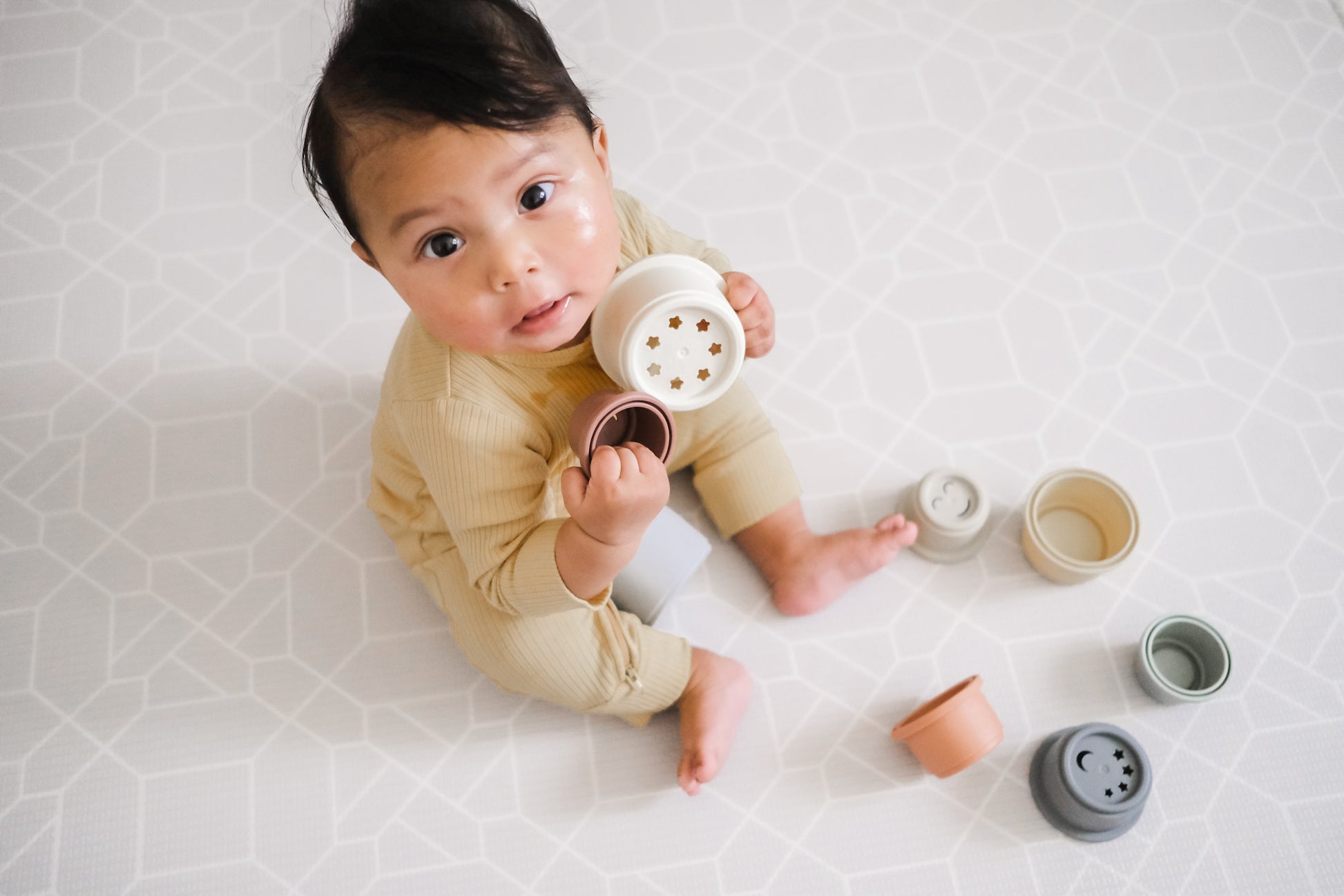 baby playing with stacking cups