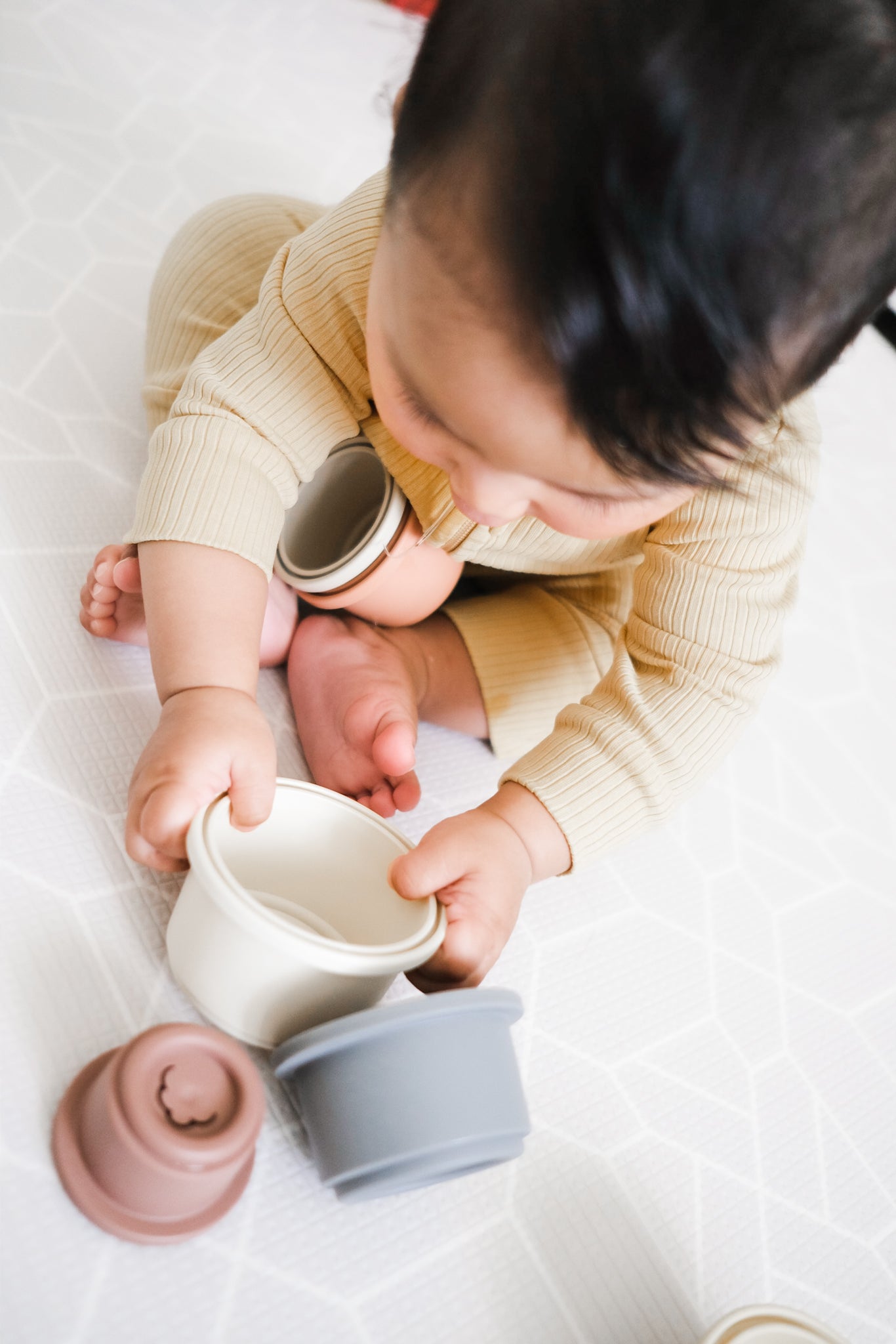 baby playing with nesting cups