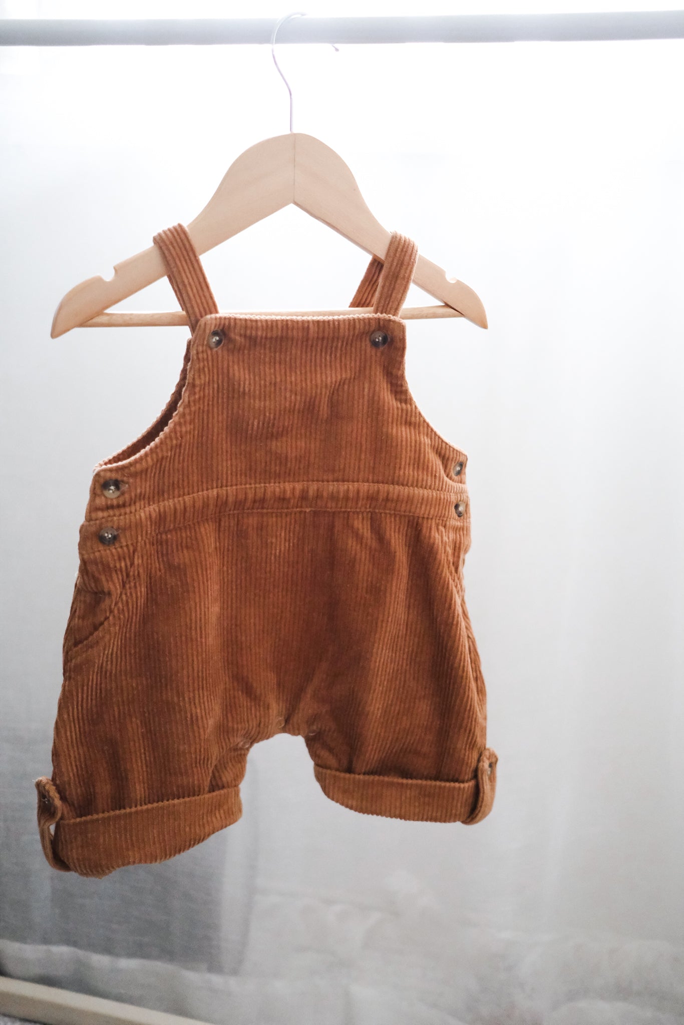 Baby corduroy overalls on hanger