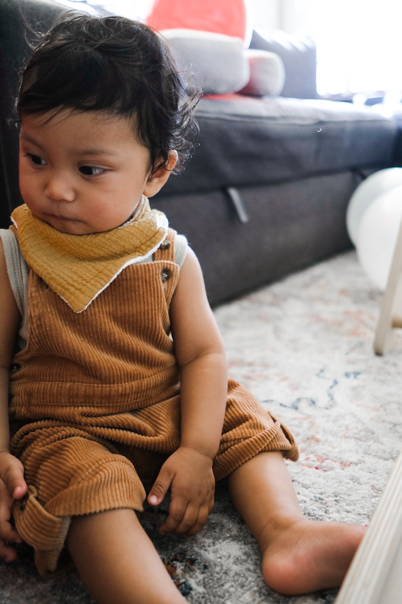 Baby wearing corduroy overalls