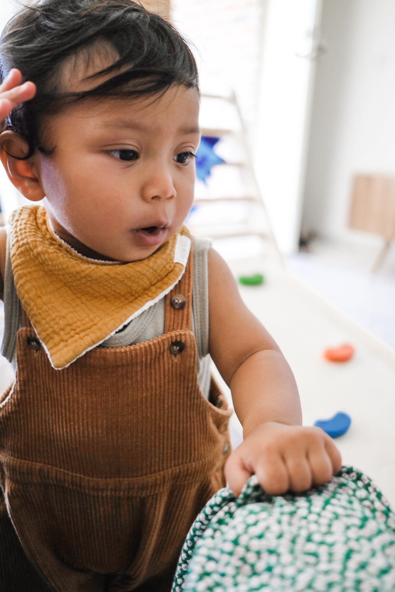 Baby wearing corduroy overalls