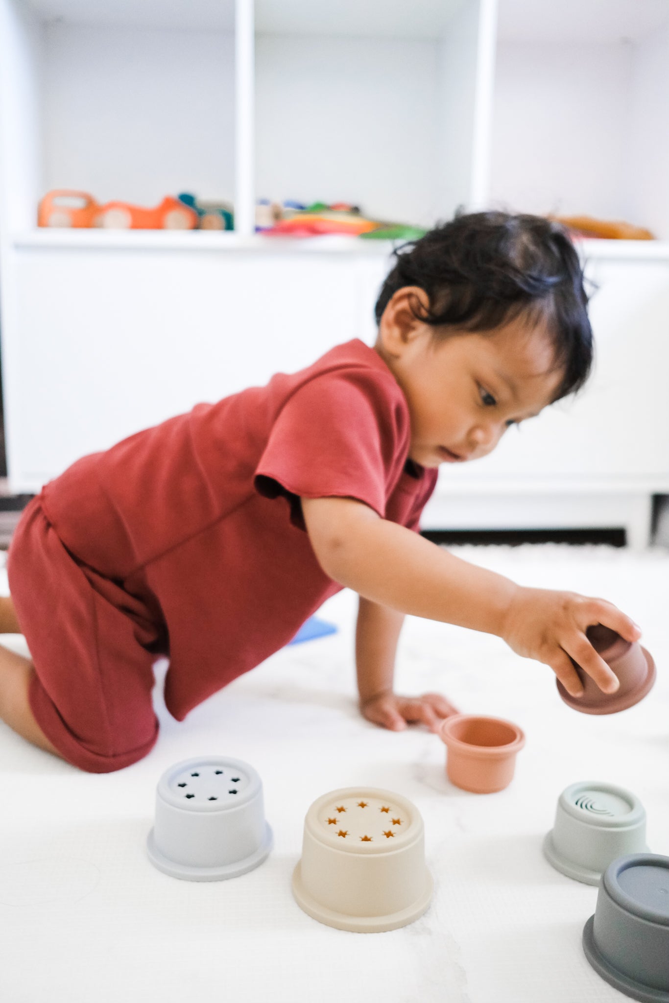 baby playing with stacking cups