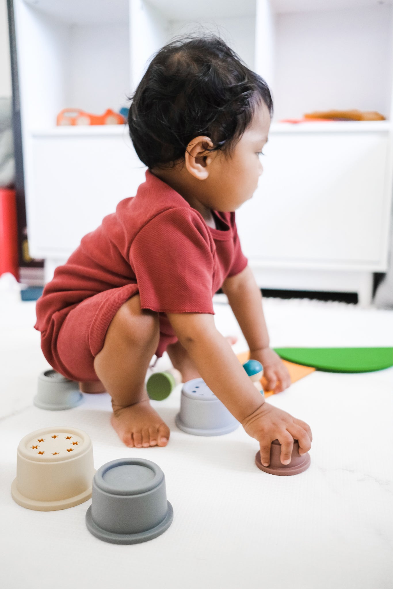 baby boy playing with stacking cups