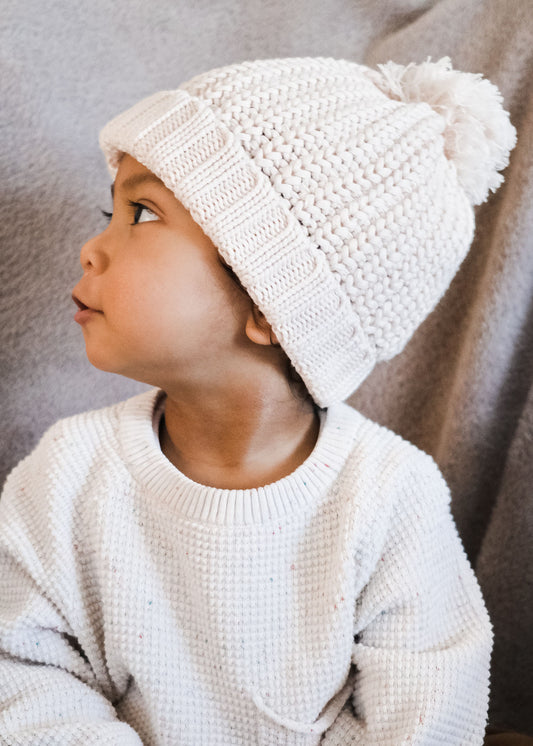 baby wearing ivory knitted beanie
