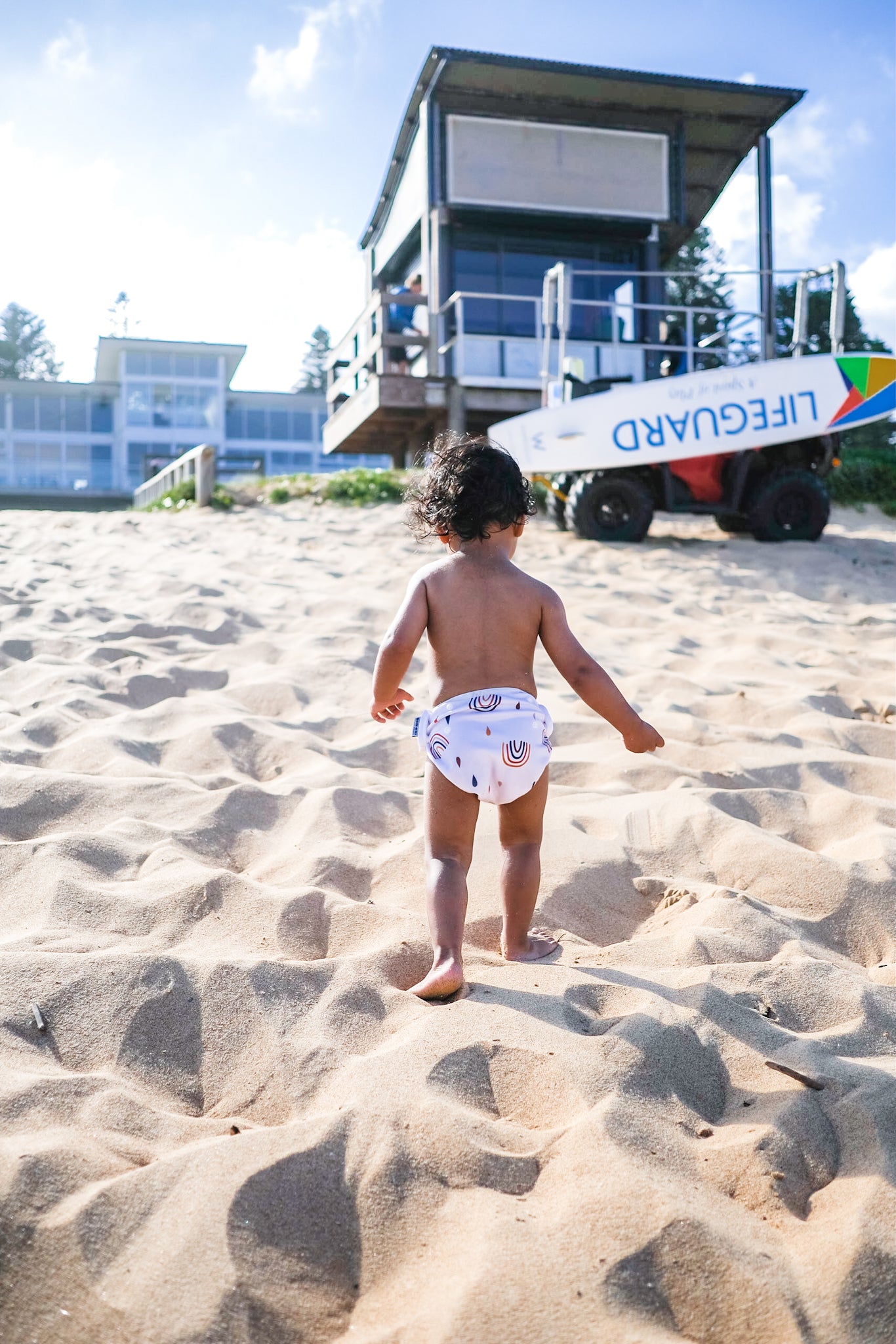 baby wearing swim nappy at the beach