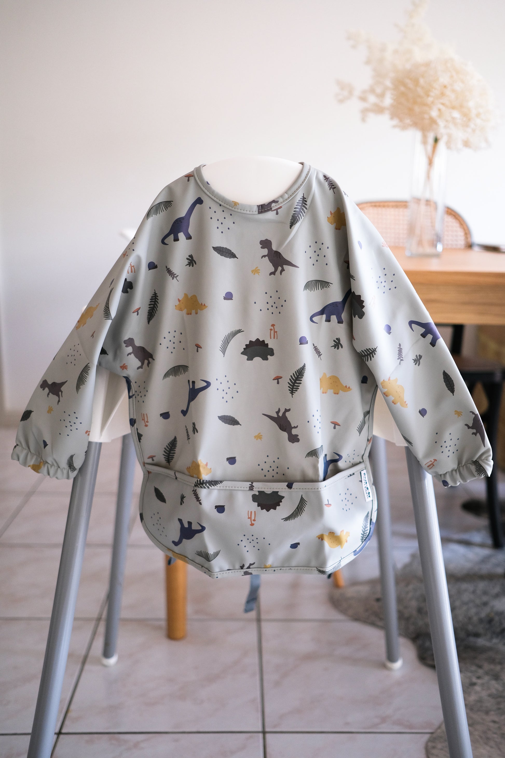 Long sleeve bib in grey dinosaurs design. Baby led weaning bibs