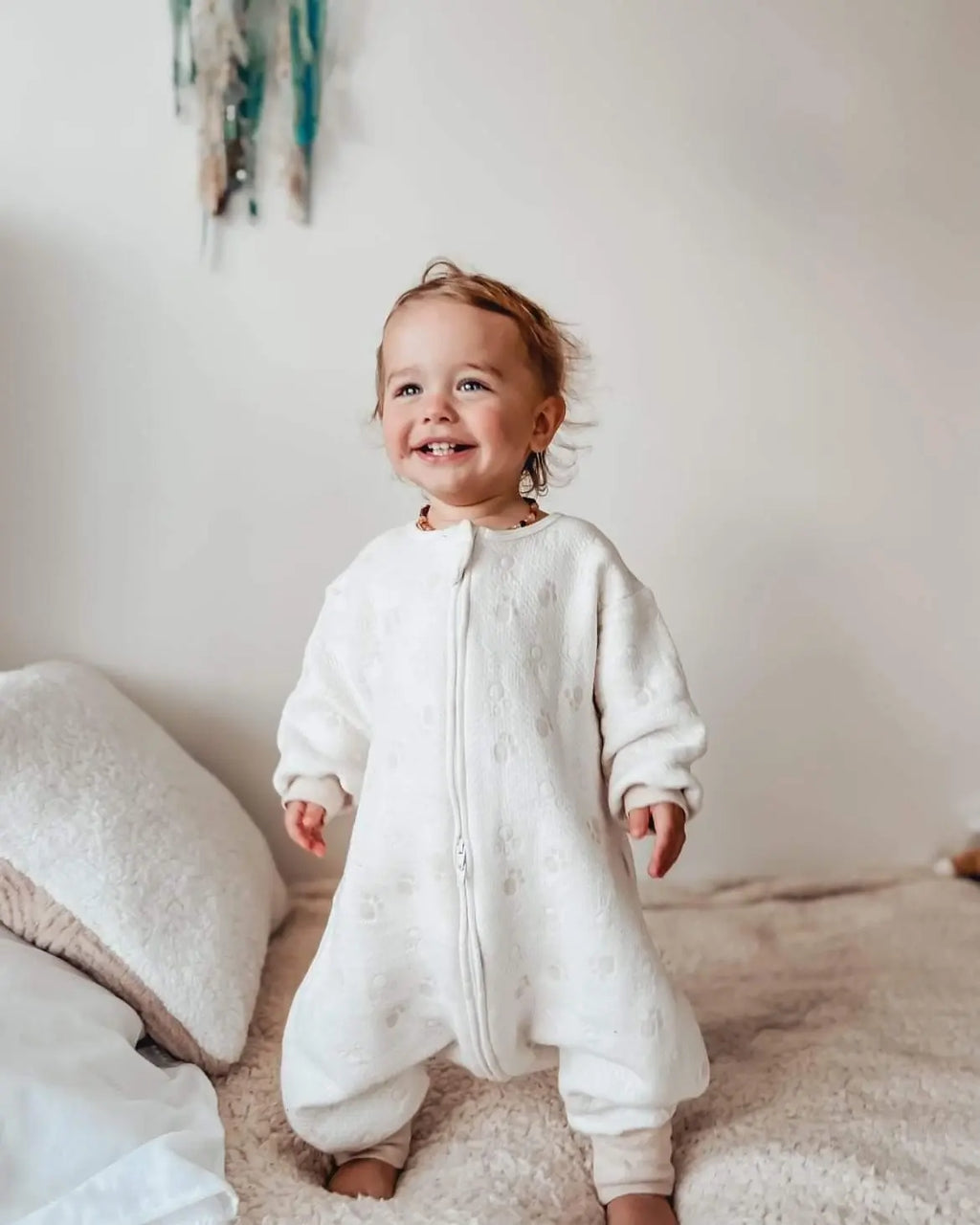 Baby boy wearing sleepsuit with paws pattern