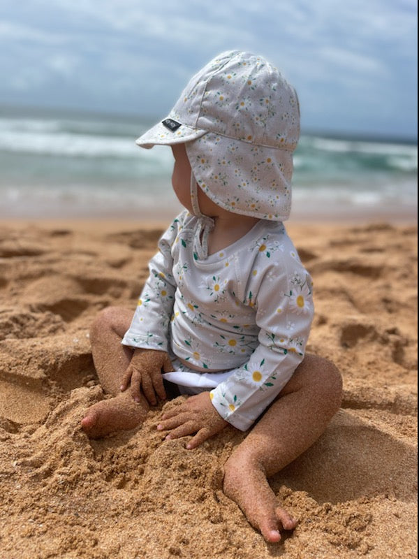 baby girl sitting on the sand